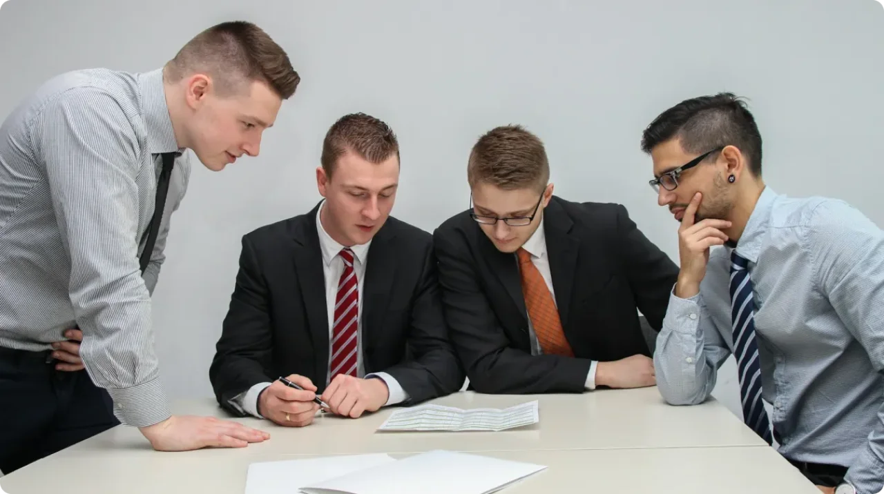 Four Men Reviewing Documents
