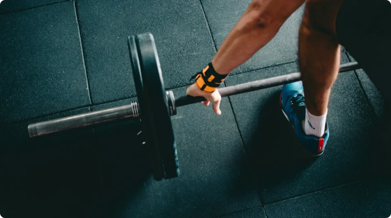 Man Holding Black Barbell