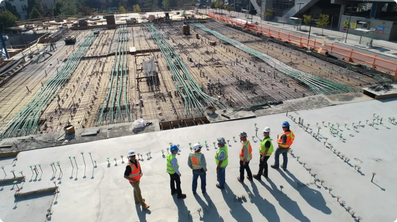 Seven Construction Workers Standing On White Field