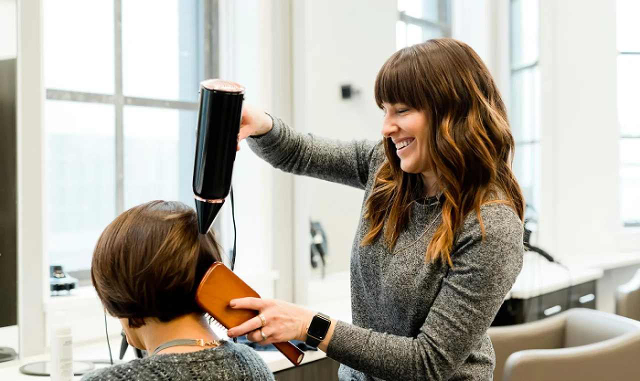 Solo entrepreneur filling out LLC paperwork with a laptop, coffee, and legal checklist on the table