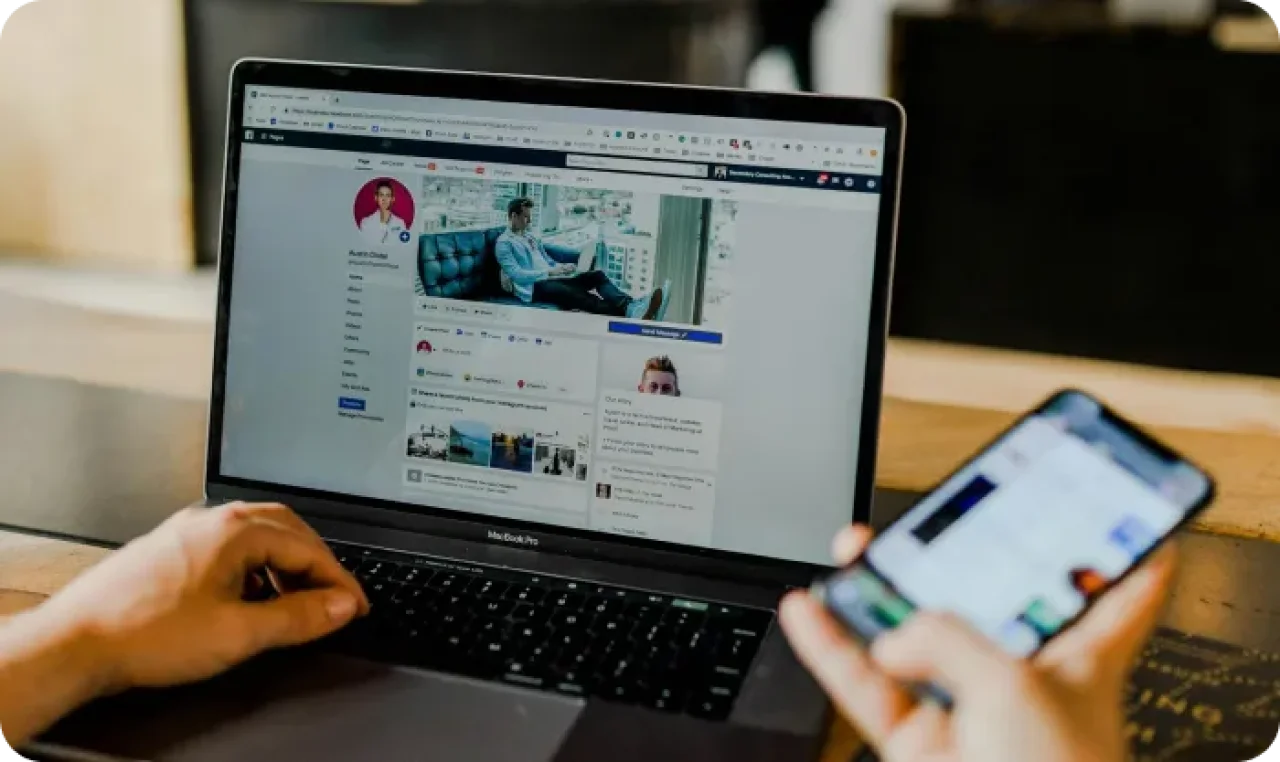 Person Using Both Laptop And Smartphone