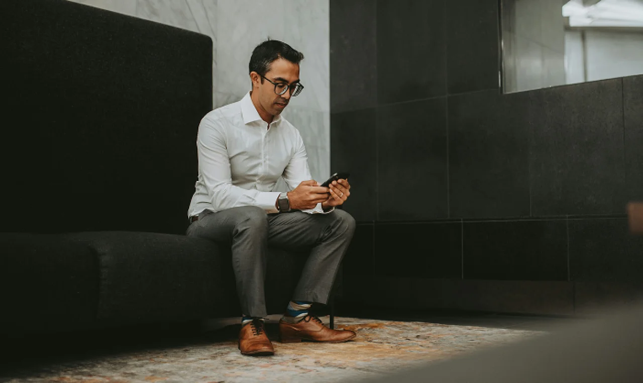 Confident solo founder researching non-equity funding options at home, surrounded by notebooks, legal documents, and a laptop displaying grant and business credit tools.