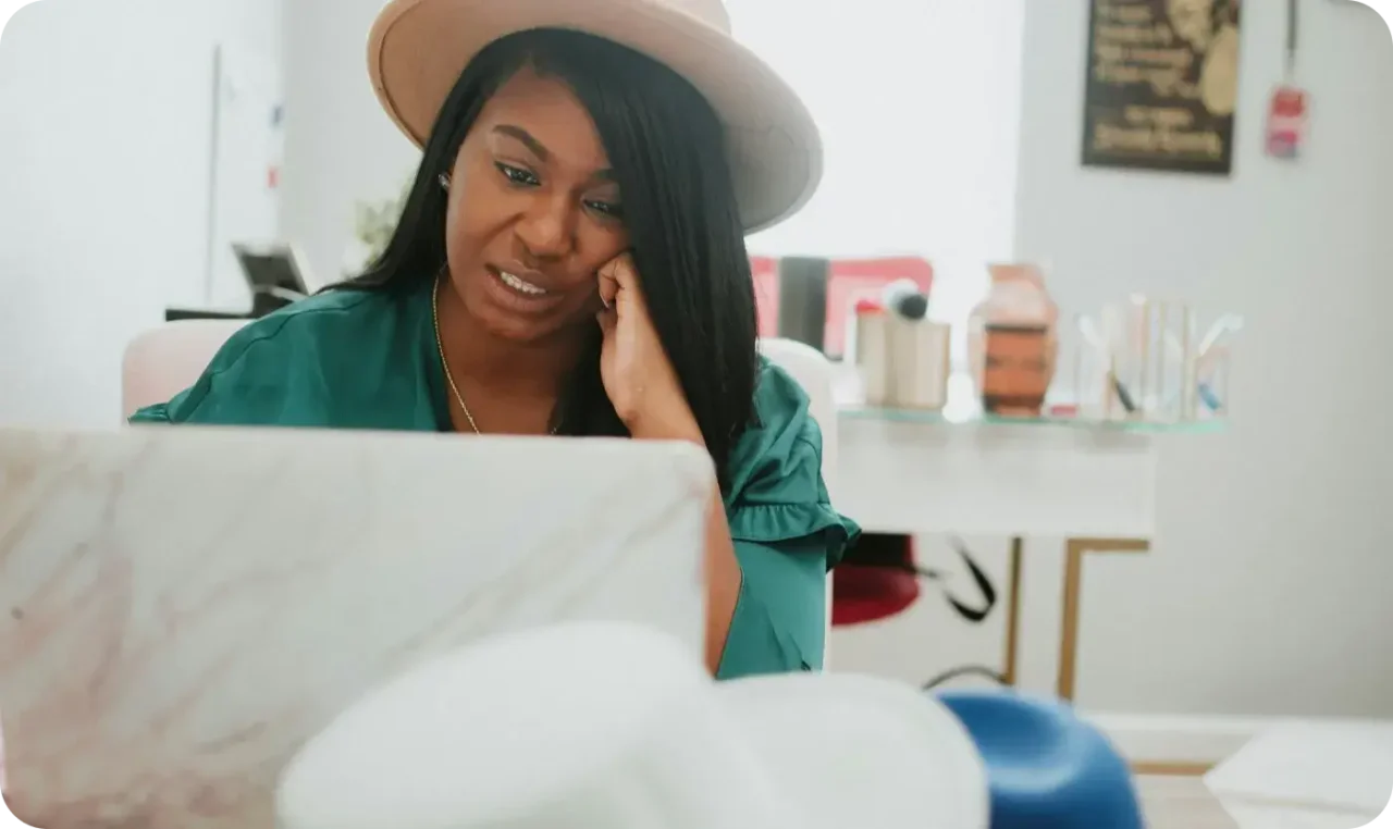 Woman Working On Laptop At Home Office Wearing Hat