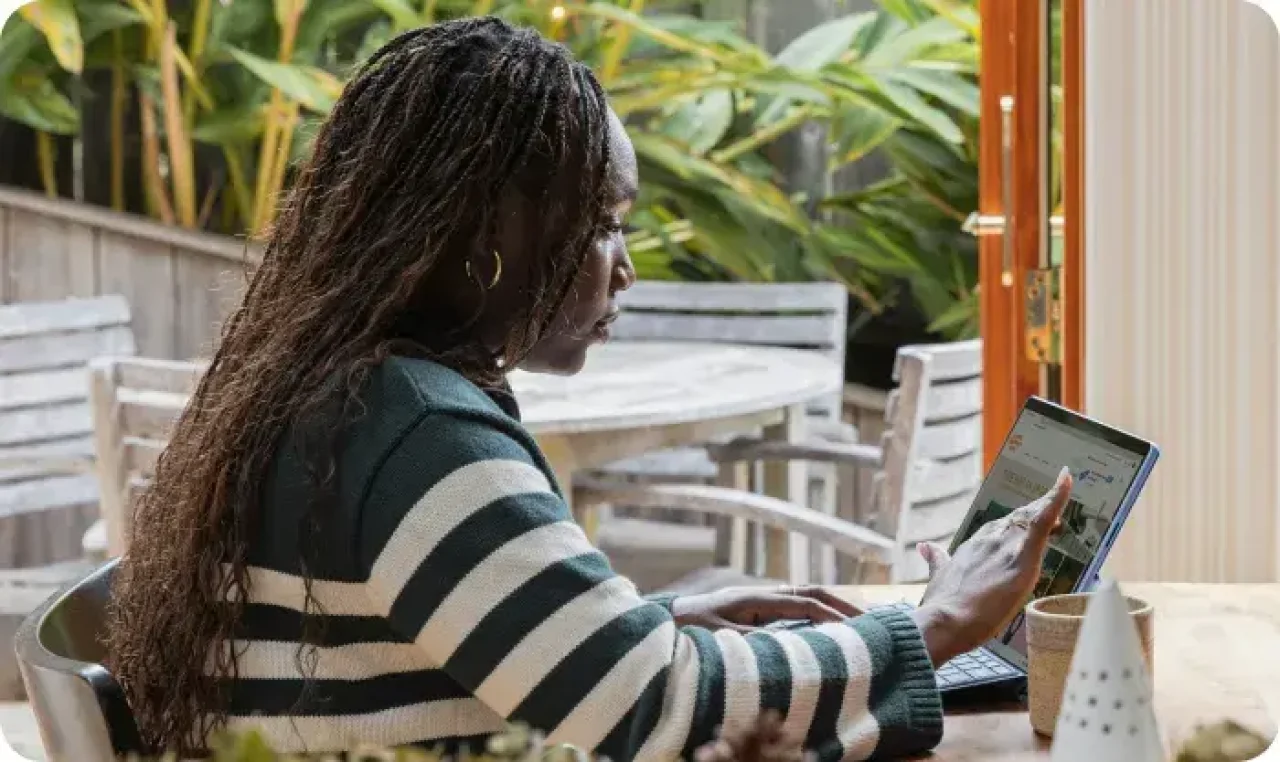Woman in a striped T-shirt working at a computer in the office