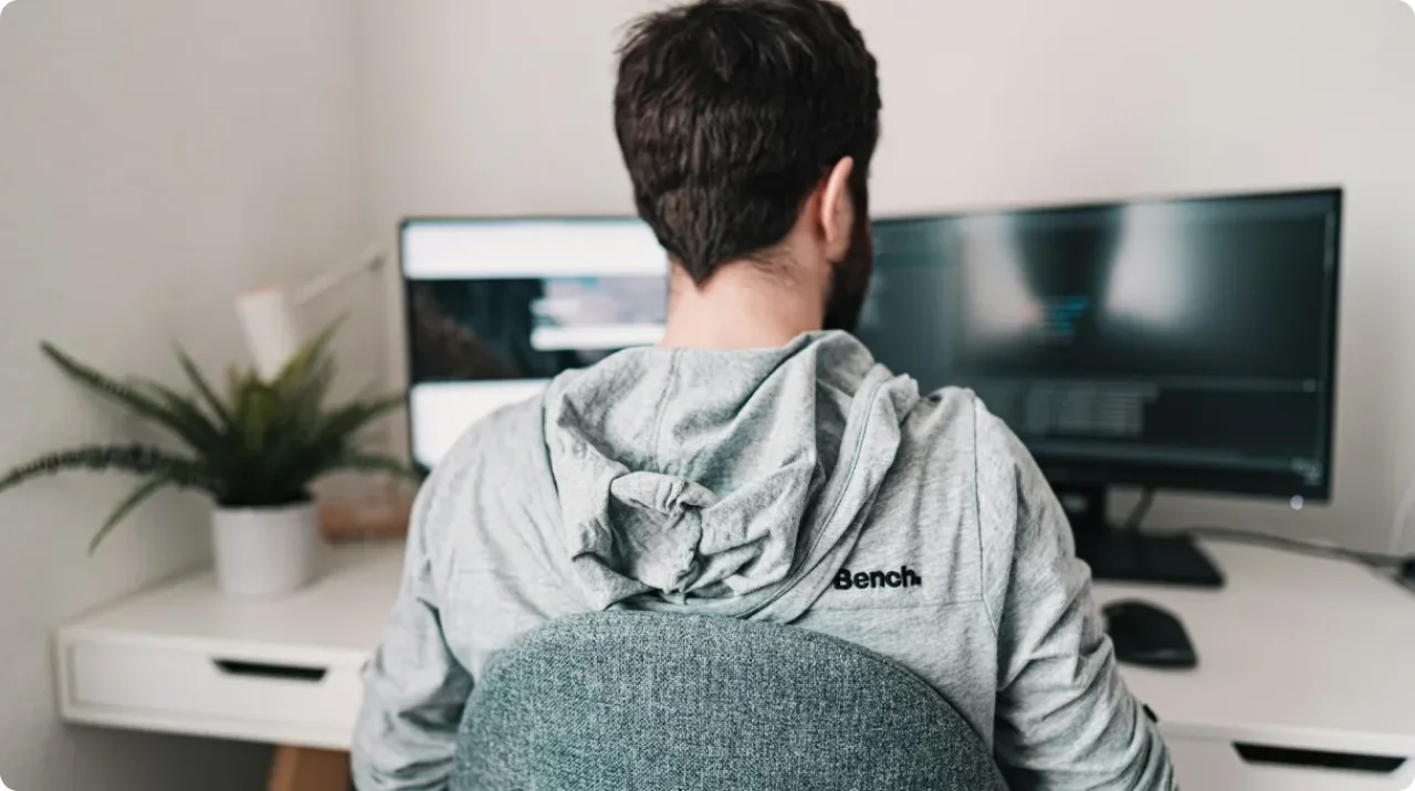 Man In Gray Hoodie Sitting On Chair