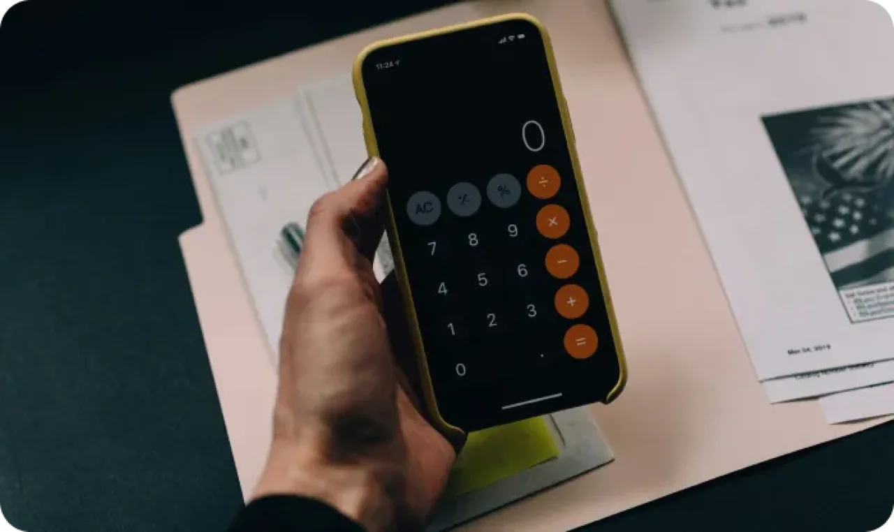 Phone With Calculator App Open In Hand