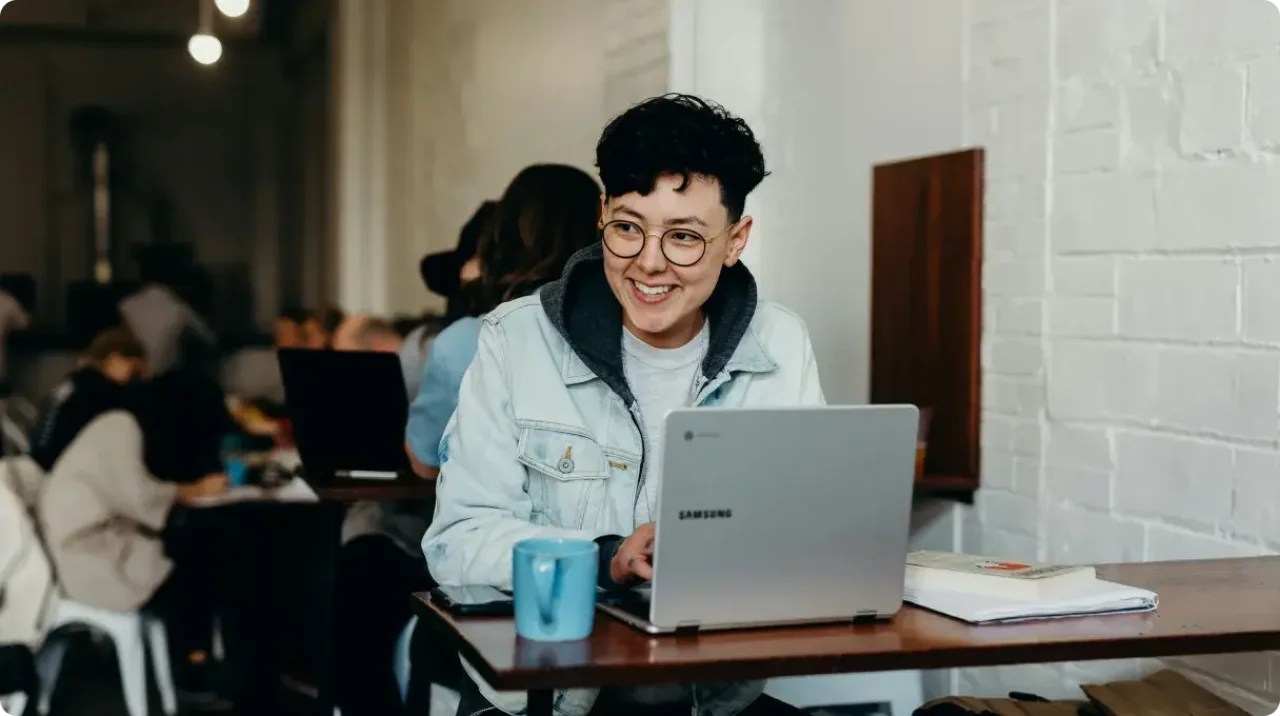 Woman with glasses sitting in caffee shop with samsung laptop
